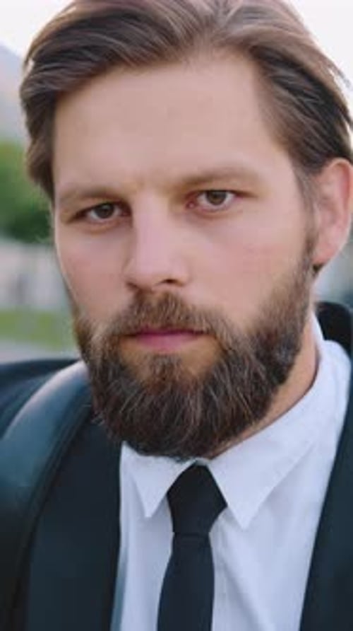 Close-up of Serious Man with Beard in Suit