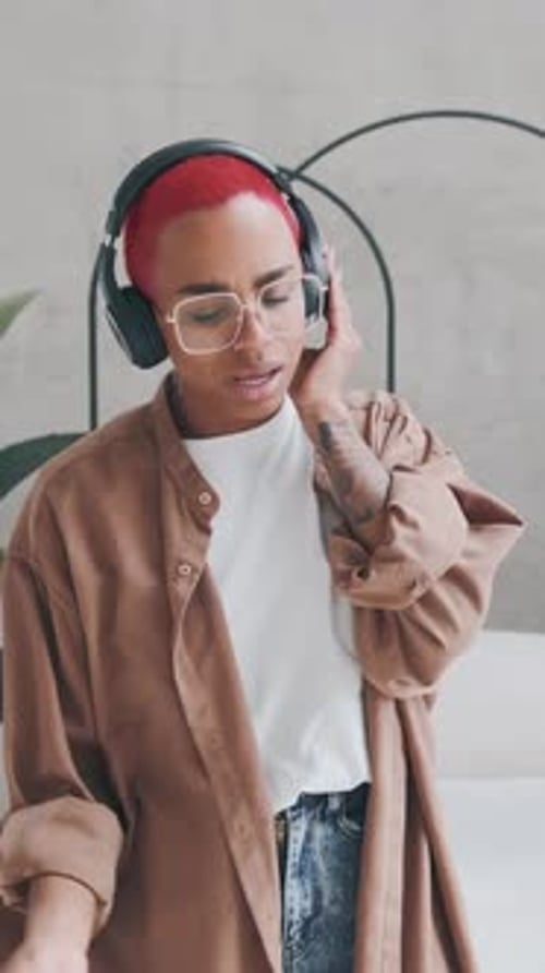 Stylish Woman Singing and Dancing with Headphones
