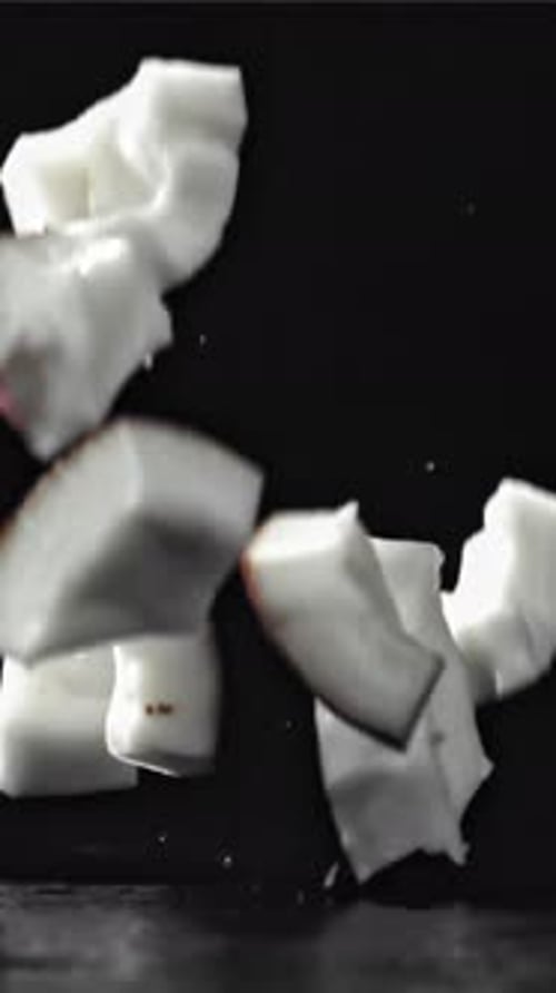 Pieces of Coconut Fall on the Table On a Black Background Filmed on a Highspeed Camera at 1000 Fps