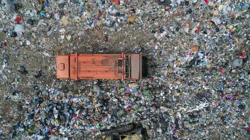 Aerial Top Down View of Truck Unloading Garbage Waste at Landfill Trash Truck Dump Waste Products