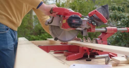 Power Saw Cuts Wood Outdoors