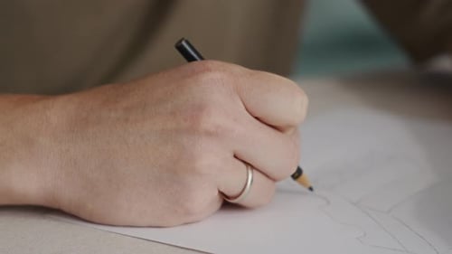 Hand Drawing a Sketch with Pencil on Paper