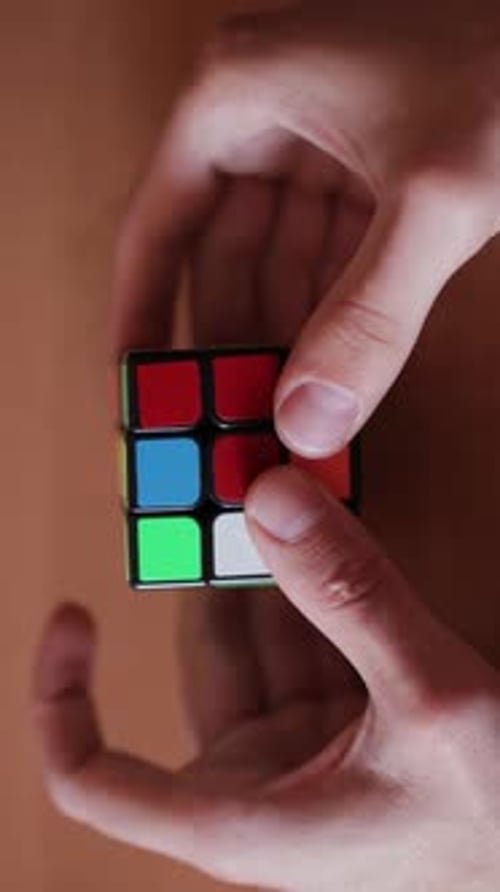 Rubik's Cube in the Hands of a Man Close Up Vertical Video