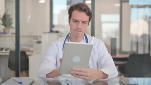 Male Doctor Working on Digital Tablet