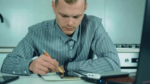 Professional Creative Man Sitting at His Desk with Laptop in Home Office Studio Scrolling Social
