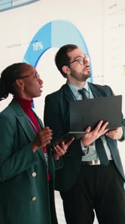 Vertical Video Female Executive and Business Partner Compile Shareholder Financial Report