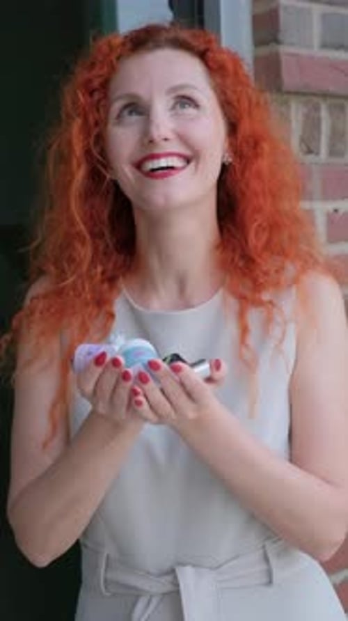 Woman Smiling While Holding Beauty Products