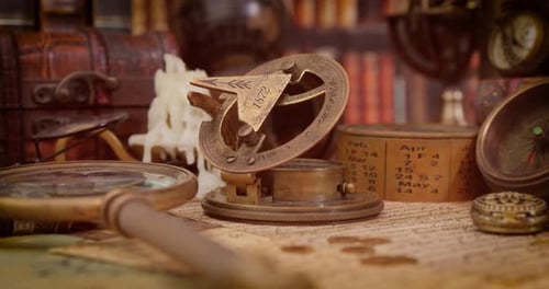 Vintage style travel and adventure. Vintage old compass and other vintage items on the table.