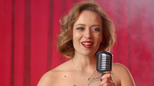 Woman Singing into Vintage Microphone Close-Up