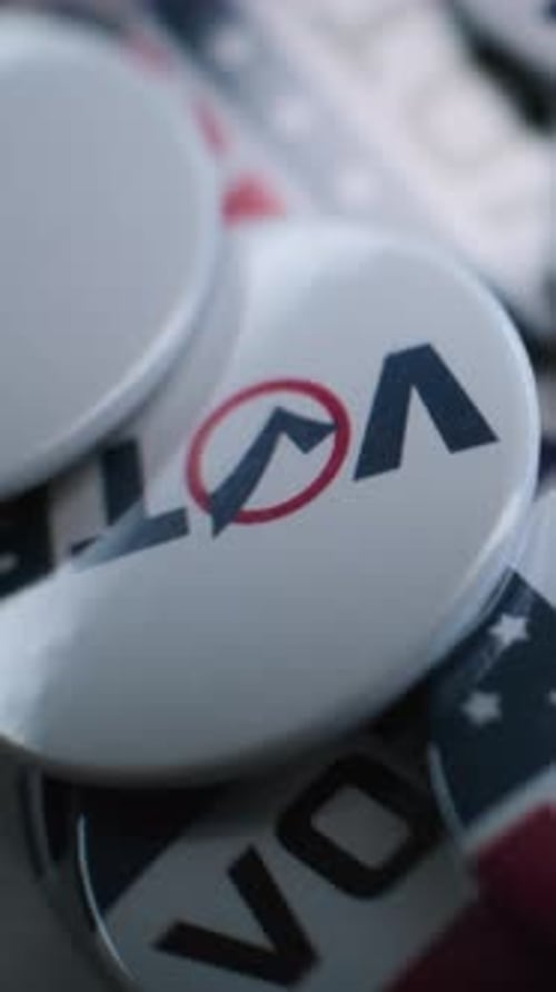 Close Up of Patriotic Badges with American Flag Logo and Inscription Vote