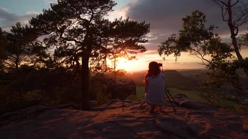 Woman Photographs Scenic Sunset in Nature