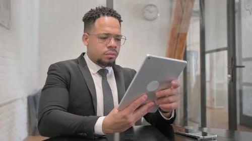 Multiracial Businessman Working on Digital Tablet