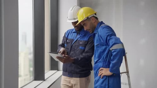 Contractor and Architect Talking and Consulting on Construction Site