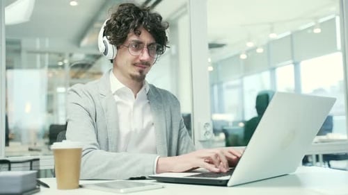 Young Adult Working at Desk in Modern Office