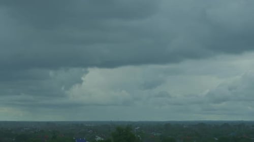 Rainstorm Over Small Town with Dark Clouds