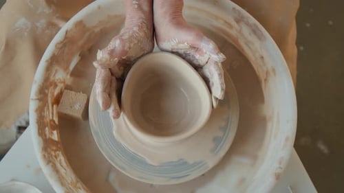Potter Shaping Clay on Wheel in Studio, Close-Up