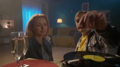 Adult Couple Celebrates with Champagne and Vinyl