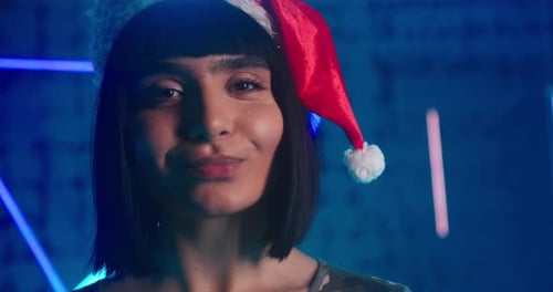 Cyberpunk Lady in Red Santa Hat Grimaces and Smiles Gently