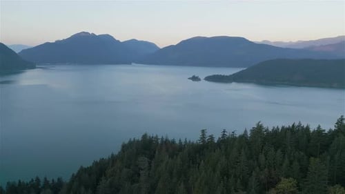 Aerial View of Lake and Green Trees in Forest Around Mountain Landscape