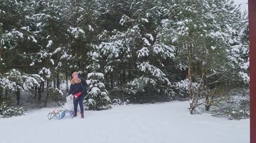 Young family playing in snow and having a snowball fight while on holiday