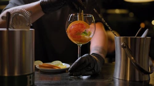 Bartender Arranges Citrus Fruit in Glass
