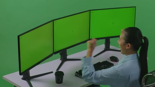 Happy Asian Woman Celebrating While Working With Mock Up Multiple Computer Monitor In Green Screen