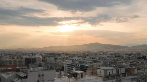 Sunset time lapse over Athens Greece city rooftops, day to night