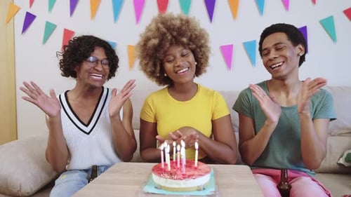 Friends Celebrate Birthday Together in Festive Living Room