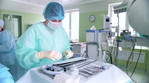 Surgeon Preparing Instruments in Hospital Operating Room