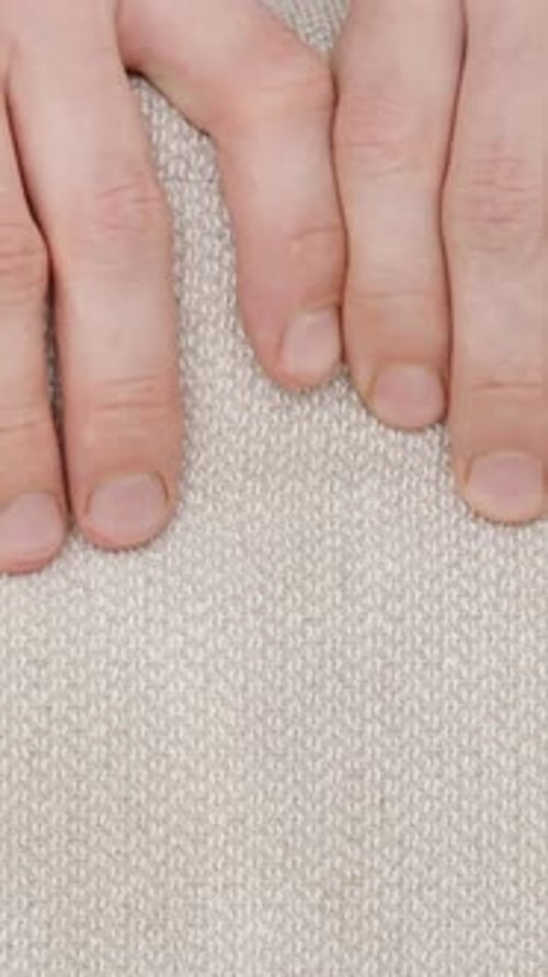 Fingers Testing Neutral Colored Fabric Softness