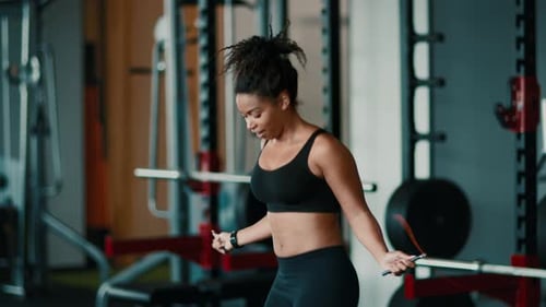 Woman Skipping Rope in Gym Focusing on Fitness Routine for Healthy Lifestyle