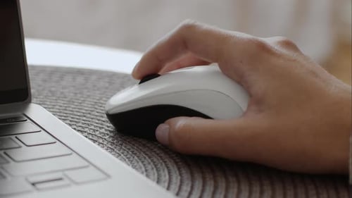 Close Up Shot of Female Hand Using Wireless Computer Mouse Unrecognizable Woman Making Online