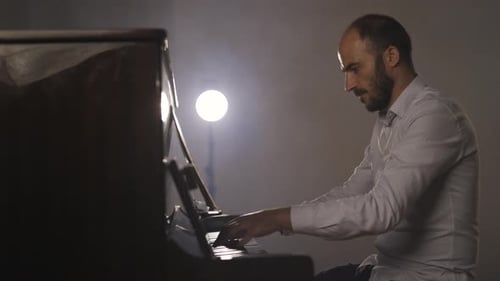 Cinematic Slow Motion Shot of Pianist Musician Playing Upright Piano Instrument in Studio,