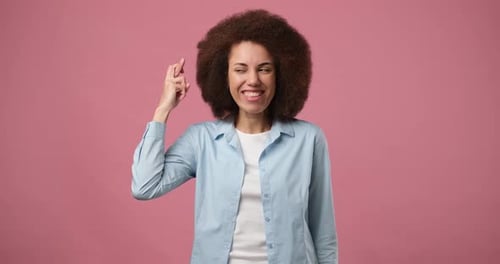 Woman With Fingers Crossed Hoping for the Best