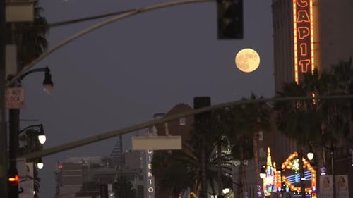 Full moon over Hollywood LA. Los Angeles California at night with citylights