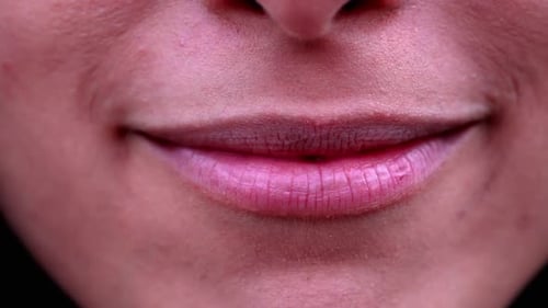 Female mouth smile extreme macro close up. 20s Woman lips smiling