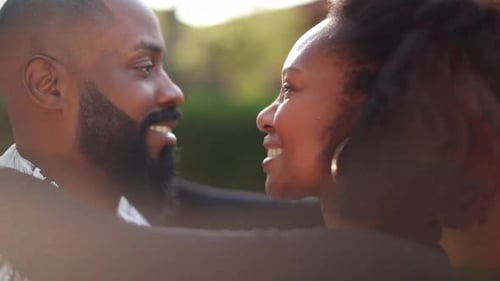 Loving Couple Embrace Outdoors in Golden Sunlight