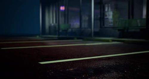 Parking Lot at Night with Wet Pavement Reflecting Lights From the Building