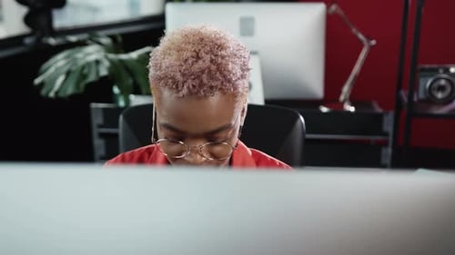 A Focused and Determined Professional Engaging in Tasks Within a Modern Office Space