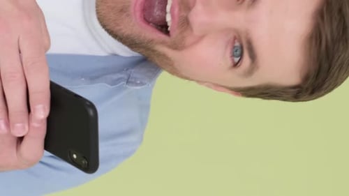 Amusingly Surprised Fashionable Guy Suddenly Read a Message on His Mobile Phone Vertical Video
