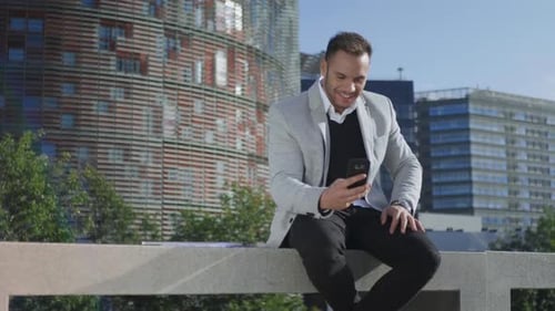 Close Up Smiling Businessman Having Video Chat on Smartphone at Street. Happy