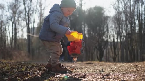 Happy Baby Child Outdoor Little Toddler Boy with Toy Car Having Fun on Walk in Park Baby Son Smiling