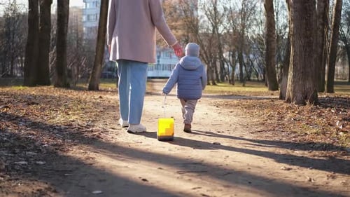 Happy Family Outdoor Back View of Mother and Her Child on Walk in Park Mom Walking with Baby Son