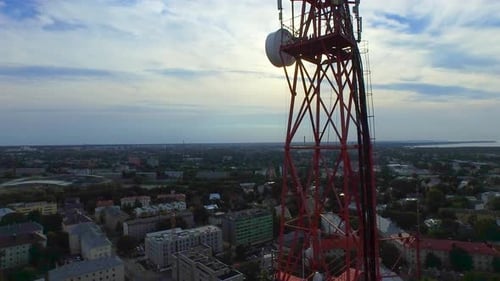 Aerial drone shot of a telecommunication radio tower mast in residential area.