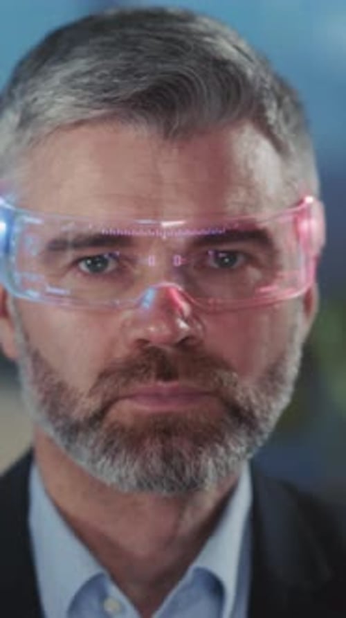 Serious Man Wearing Futuristic AR Glasses in Office