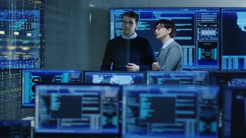 Data Security Team Collaborating in a High Tech Office