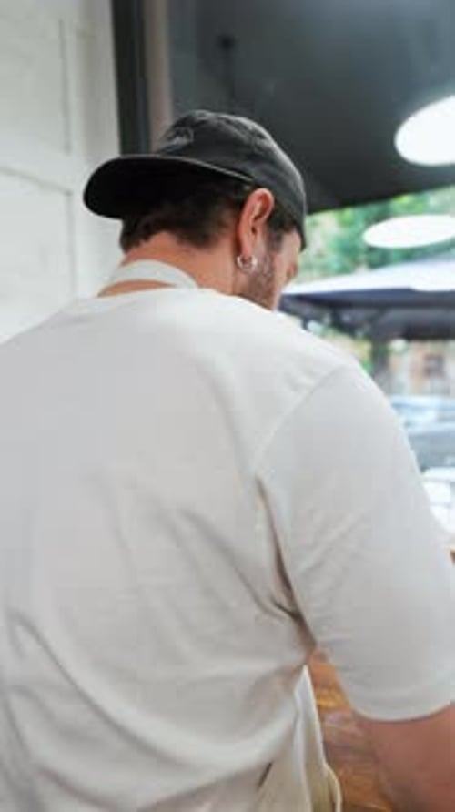 Bakery Worker Prepares Dough at Counter