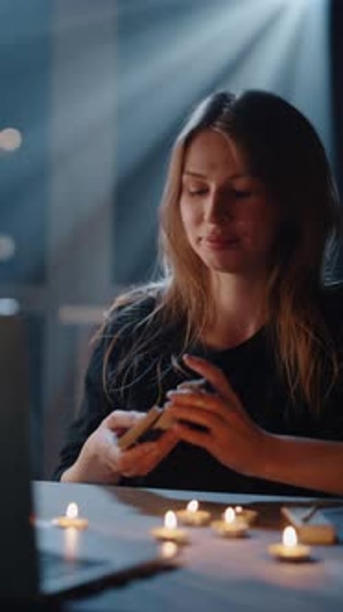 Woman with Tarot Cards and Candles at Night