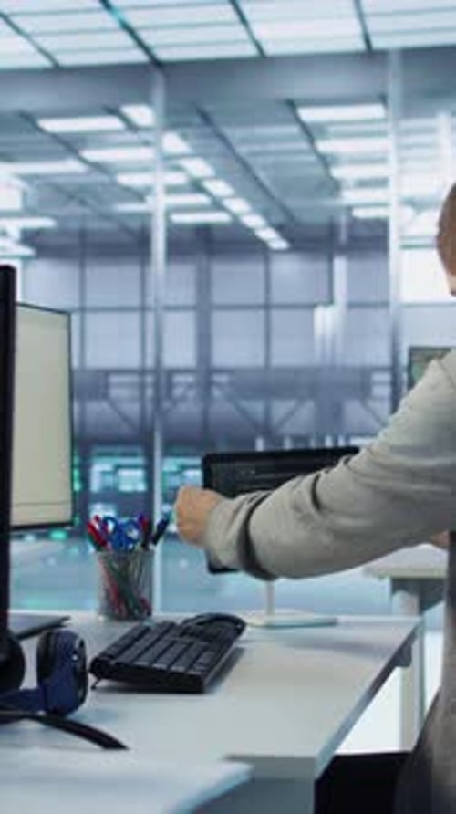 Man Coding at Desk in Modern Office
