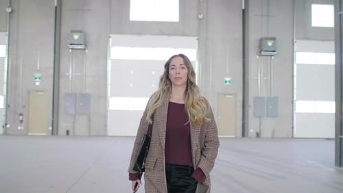 Confident Inspector Walks Empty Warehouse